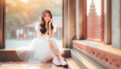 A beautiful Asian girl, dressed in a white dressand pink sneakers, kawaii chic style, 32 kUHD. themorning sun shines through the screen window soft lights, smiling and looking at the distance